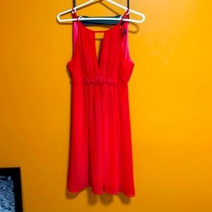 Flowy coral dress with keyhole front & built in liner. Button back do up